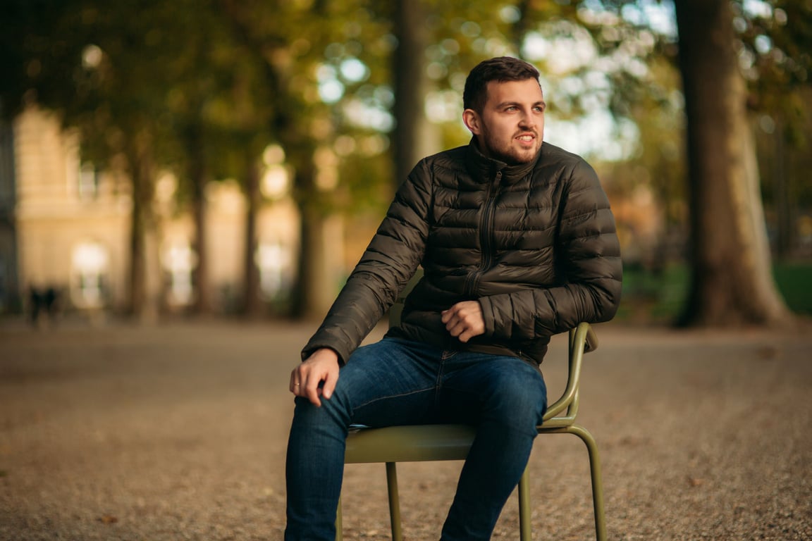 Man Sitting on a Bench in the Park